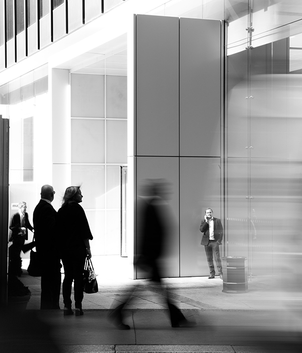 blurry man walking in black and white