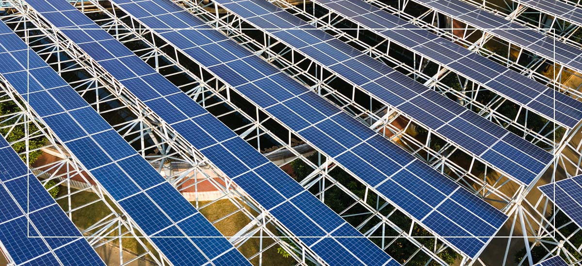 Aerial view of solar panel array mounted on white metal framework